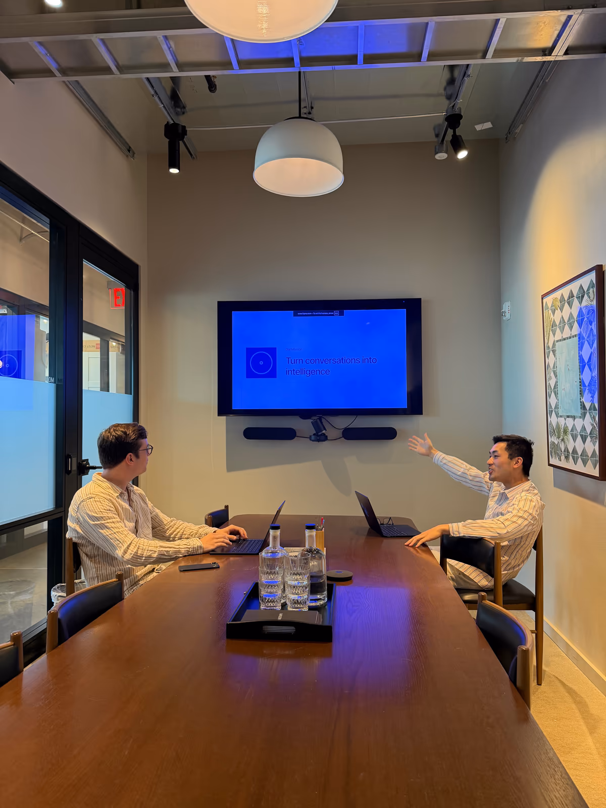 Two Arbor teammates working through a live demo in a conference room