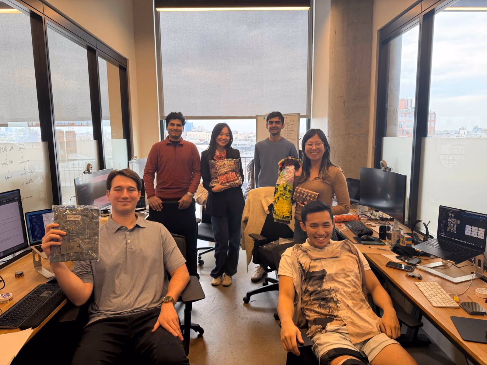 Arbor teammates celebrating a swag drop in the office