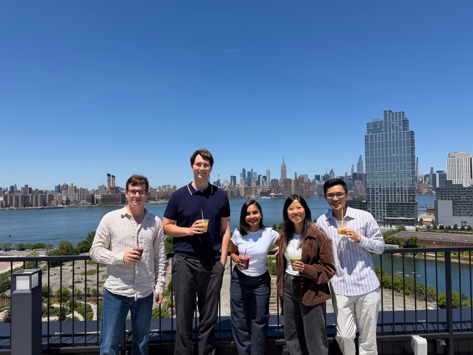 The Arbor team on a Brooklyn rooftop with the Manhattan skyline behind them